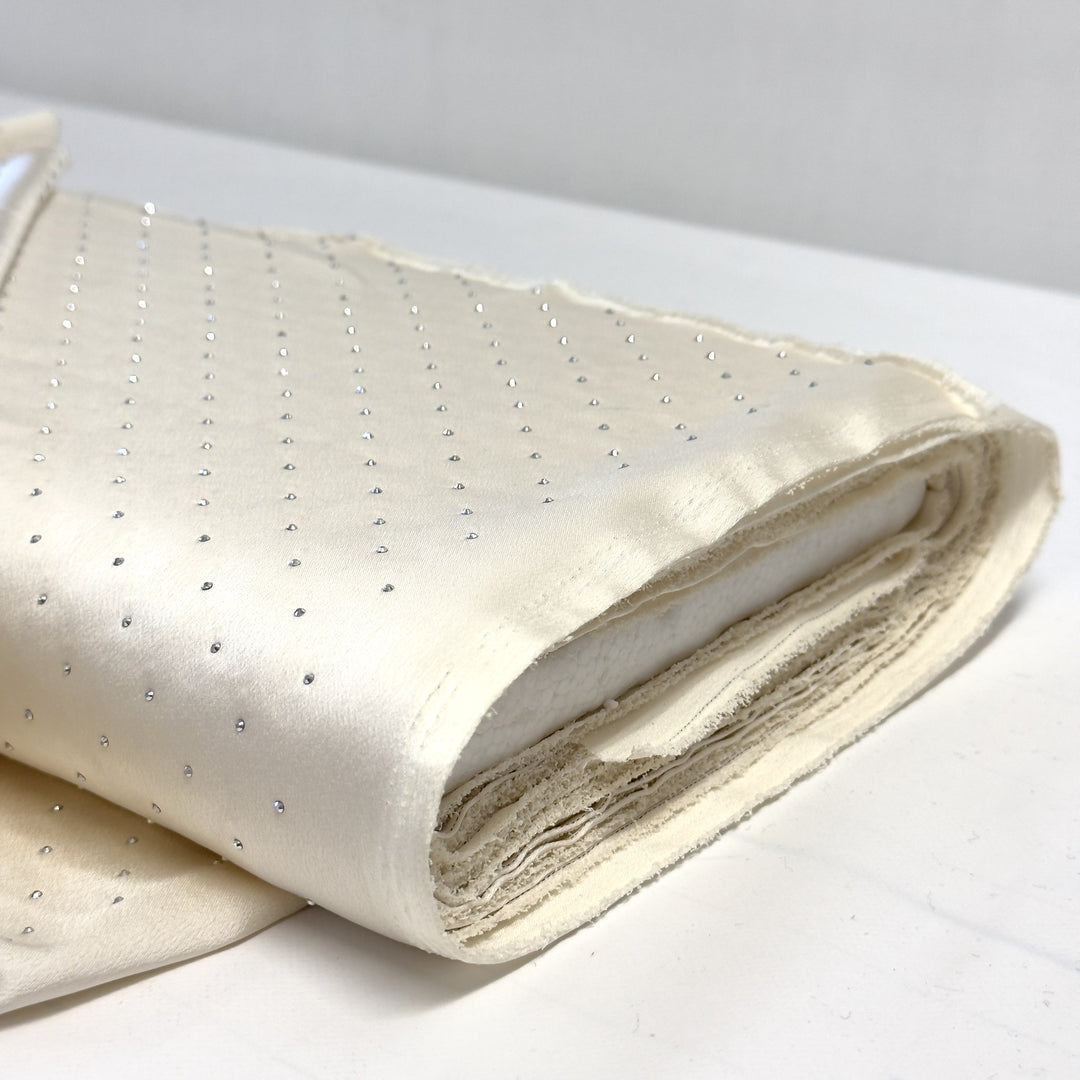 Bolt of cream rhinestone fabric, shiny side