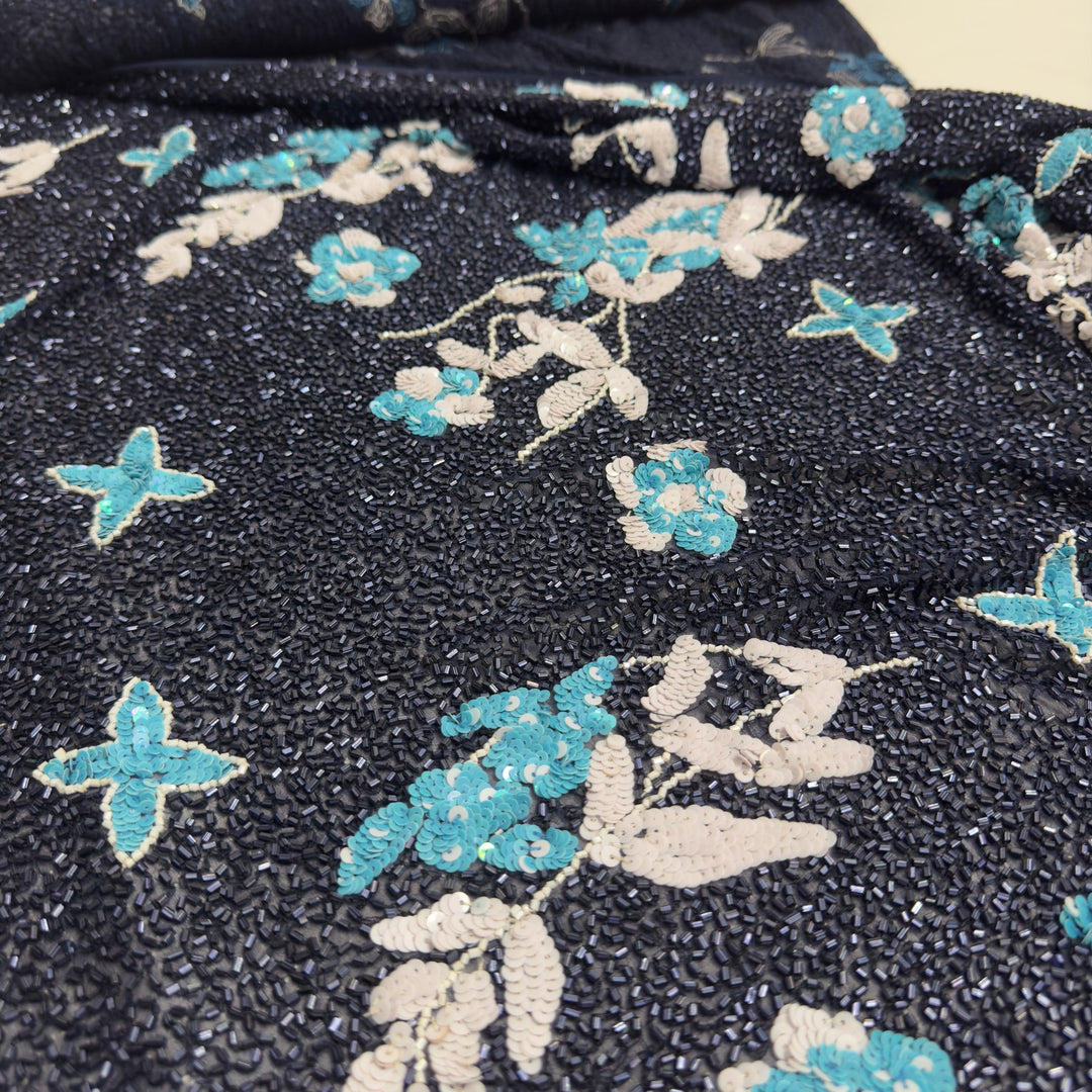 Flower and leaf motifs in turquoise and white sequins