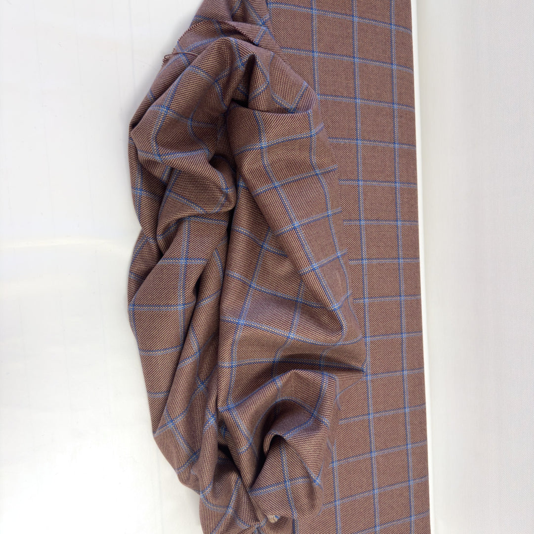 Pure wool check fabric laid out and draped: large checks with blue and light blue lines