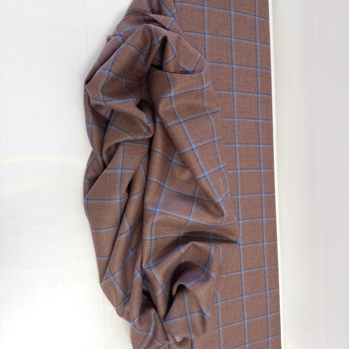 Pure wool check fabric laid out and draped: large checks with blue and light blue lines