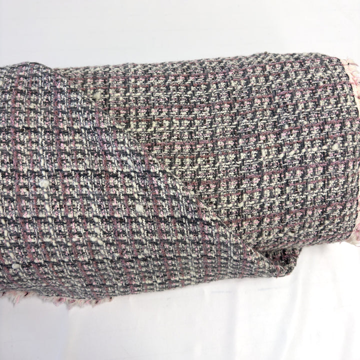 Wool bouclé check fabric in pink, grey and white on the bolt, on a white background