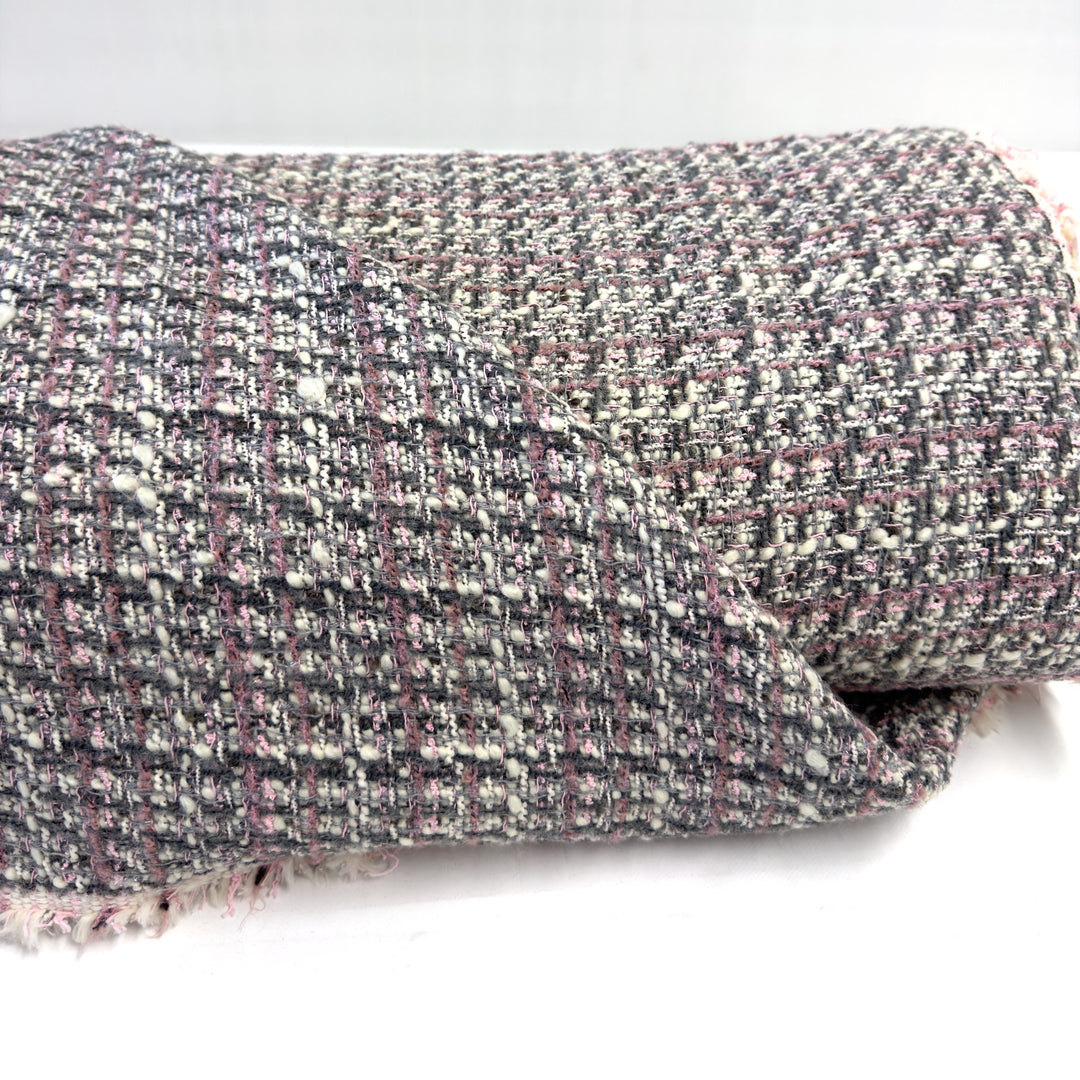 Folded pink and grey check fabric, with the lines of the check in dusty pink