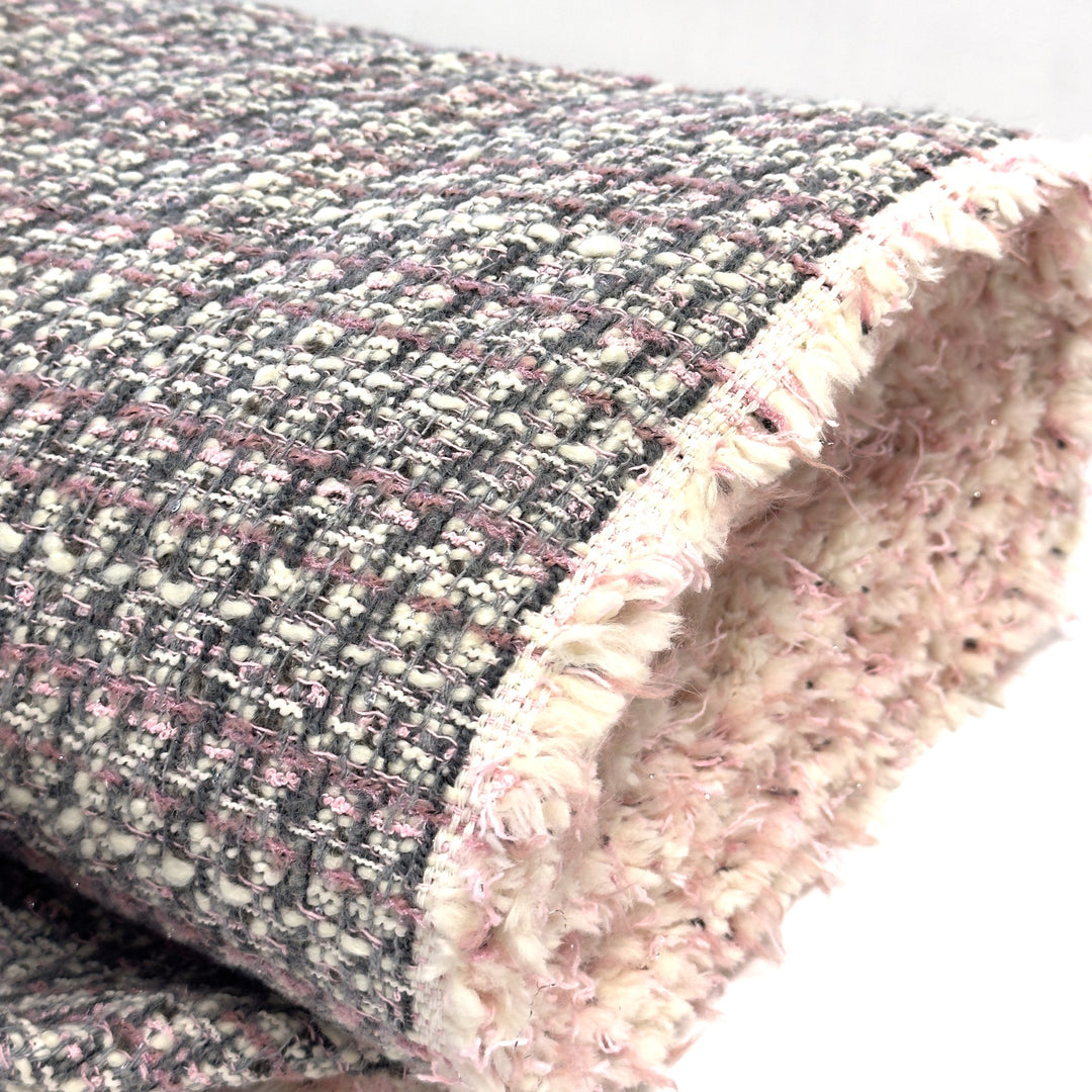 Edge of the bouclé fabric with its light-coloured fringe