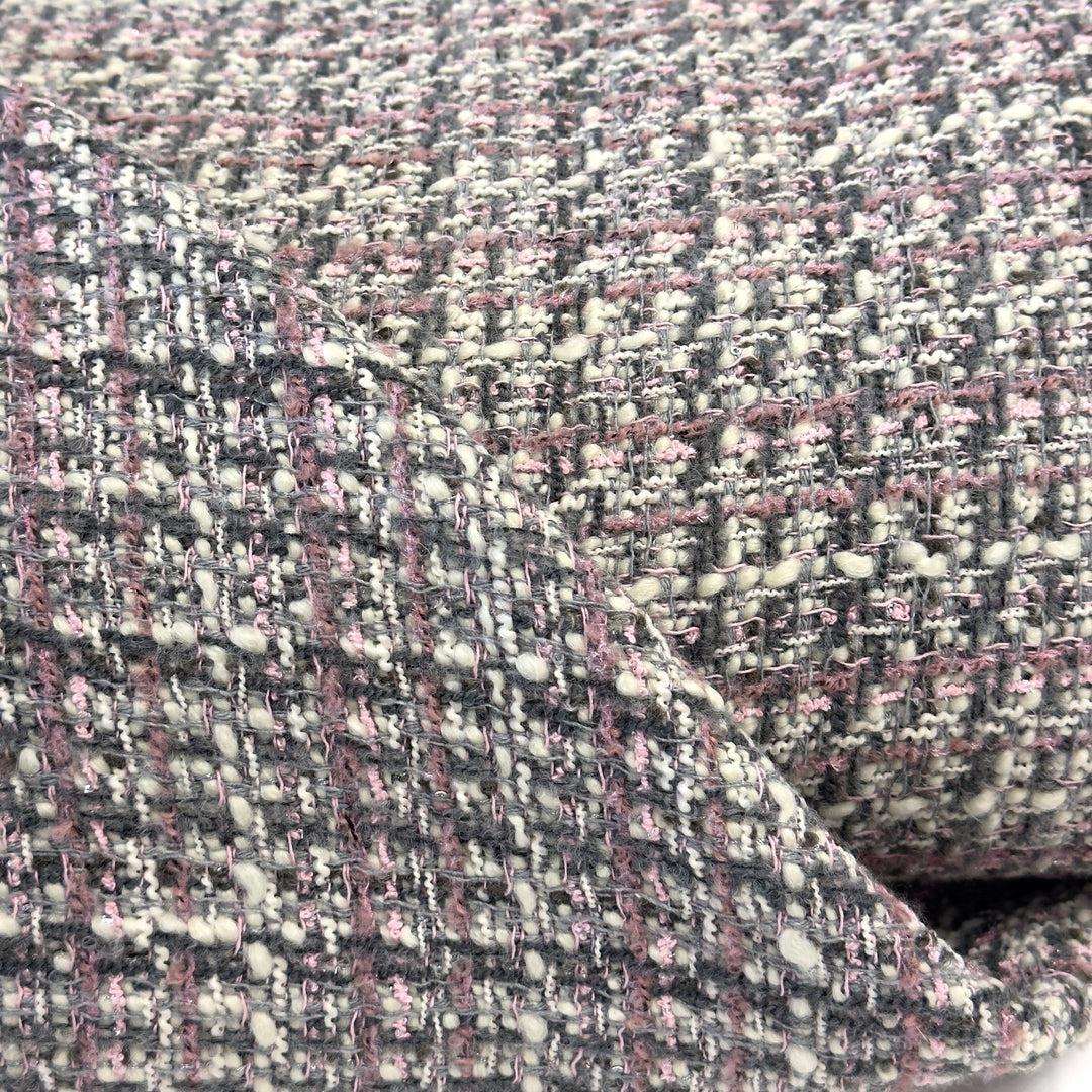 Close-up of the bouclé weave: cream, grey and pink yarns with small knots