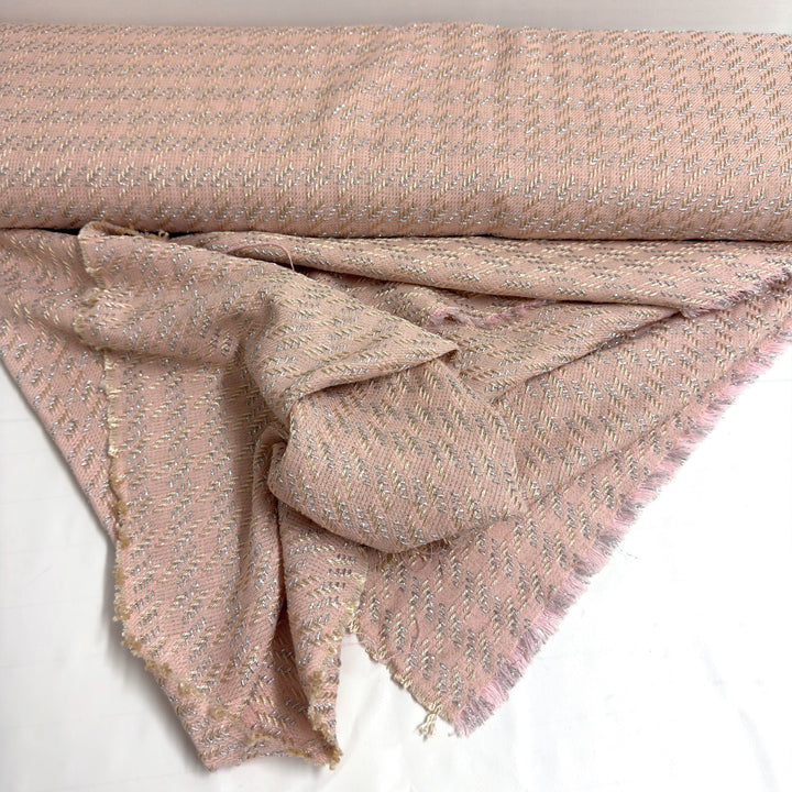 Pink fabric draped below the roll