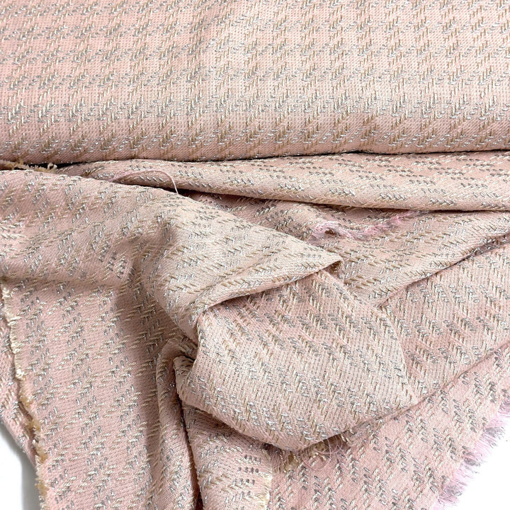 Close-up of the pink fabric with silver threads, draped
