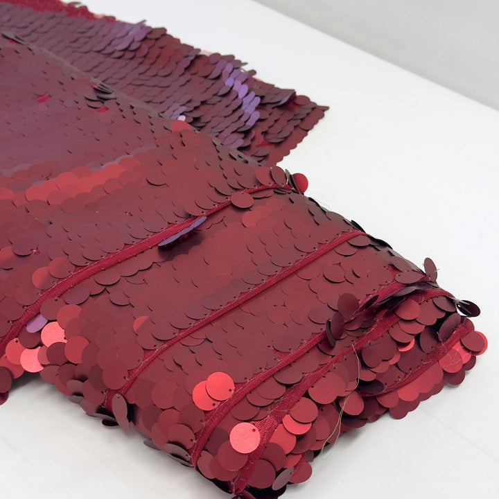 Folded red sequin fabric, with the rows of stitching
